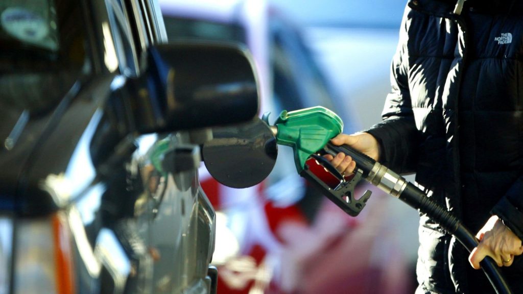 A Person fills fuel at a petrol pump in Liverpool